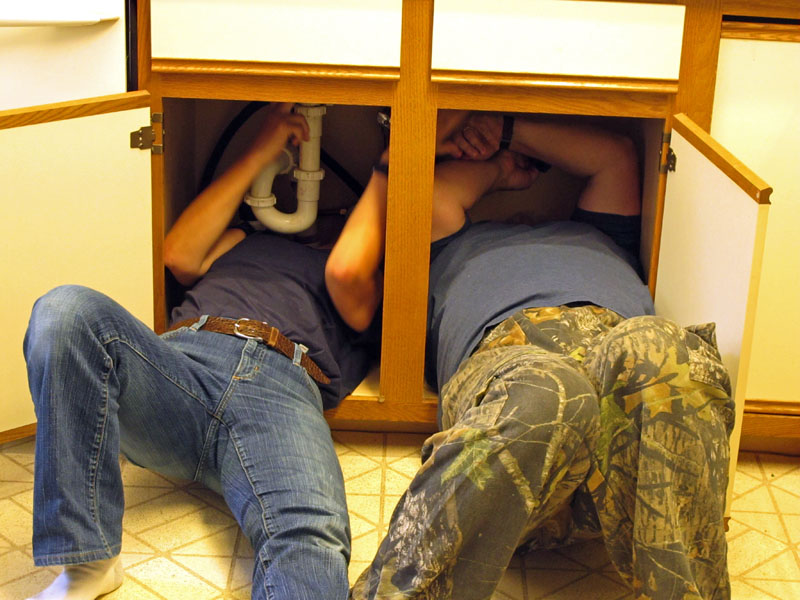 Volunteers install a new kitchen faucet - Sept 3, 2012