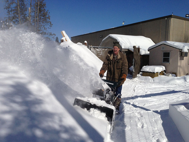 John snowblowing path at Bear Center