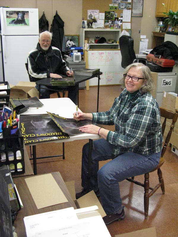 Lynn and Sue signing calendars