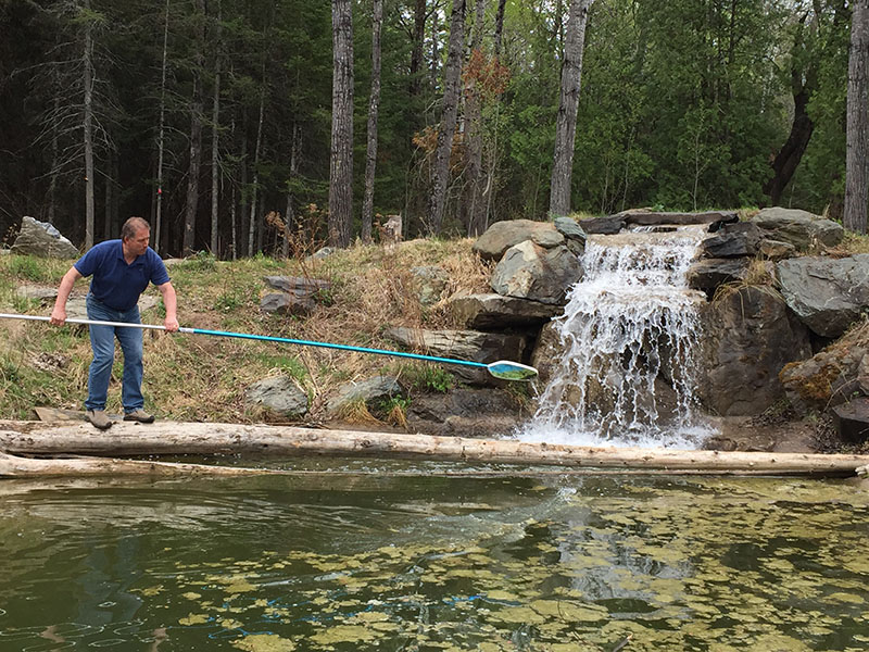 Scott Edgett cleaning the pond